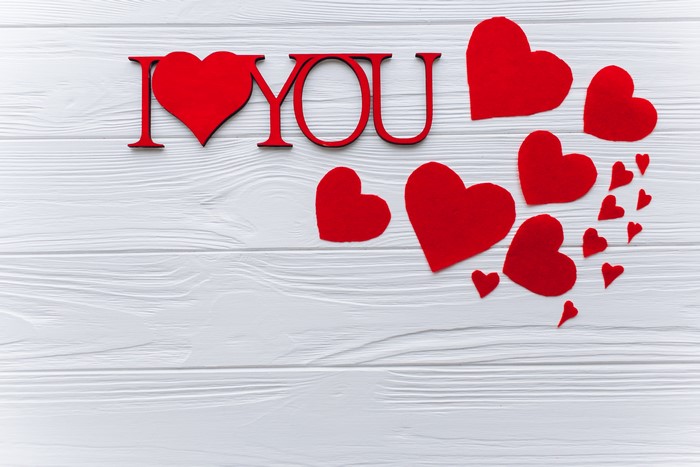 I Love You red hearts on white wooden background