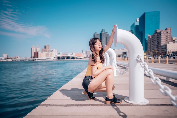 Asian woman posing by the waterfront