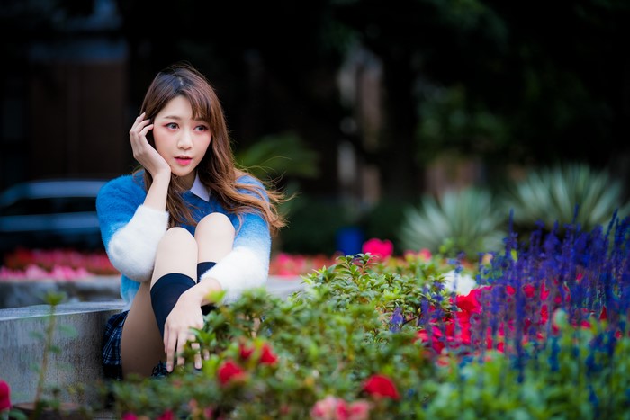 Asian woman with brown hair wearing a sweater