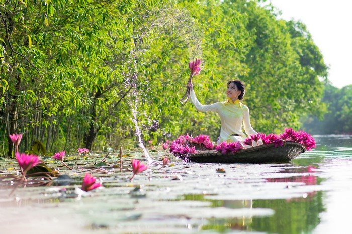 Woman in a boat with water lilies