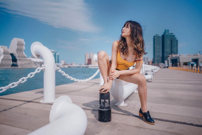 4K Asian Woman Sitting by Waterfront