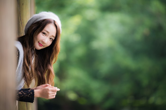 Asian woman with brown hair wearing a beret