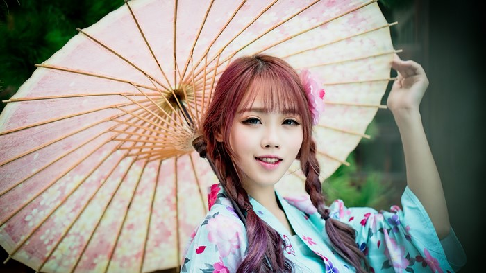 Asian girl with braid hair holding an umbrella