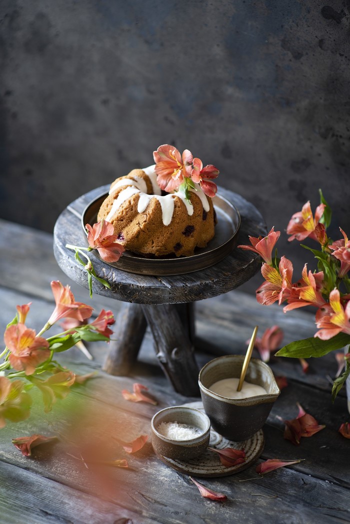 Bundt cake with icing and alstroemeria flowers