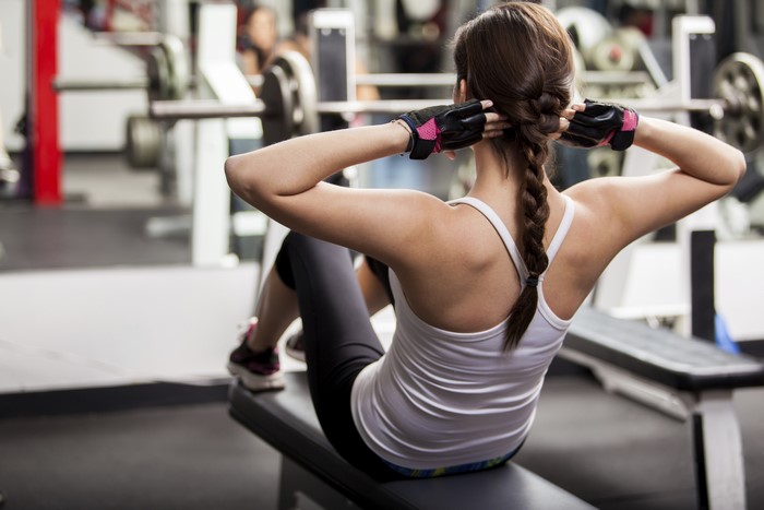 Woman doing sit-ups in a gym