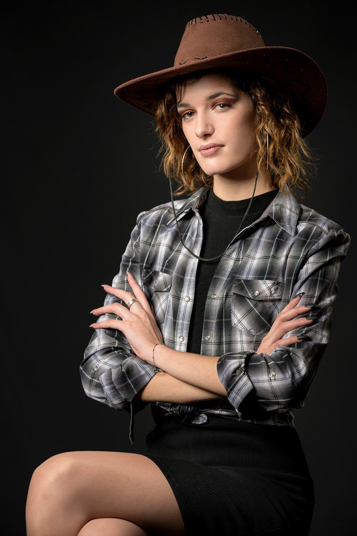 Morgane wearing a cowboy hat and plaid shirt