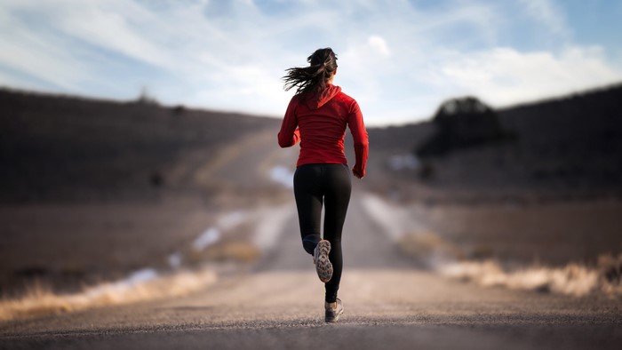 Woman running on a dirt road