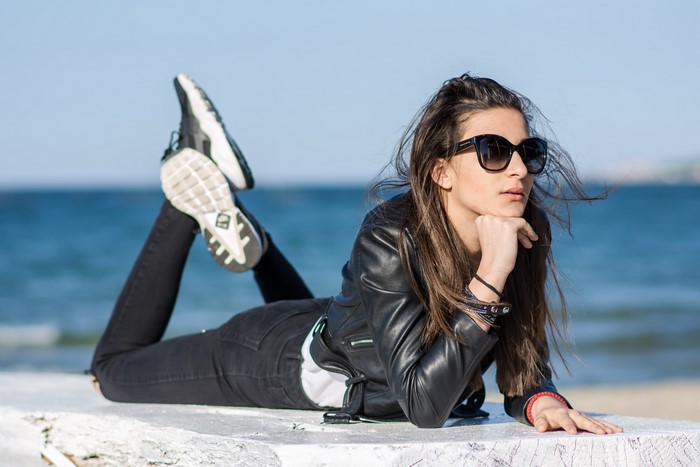 Woman in Jacket and Sunglasses Lying Down