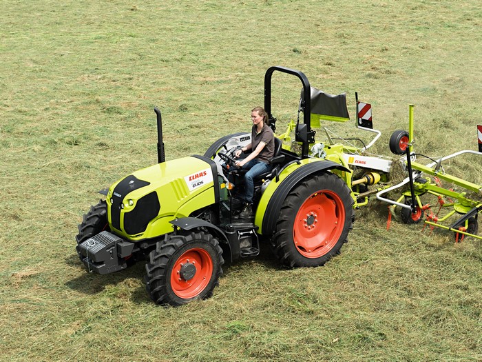 Claas Elios 220 tractor with a rake in a field