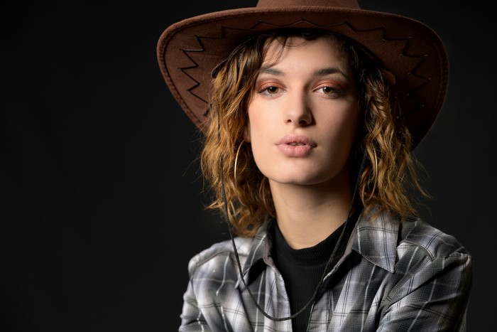 Morgane wearing a cowboy hat and plaid shirt