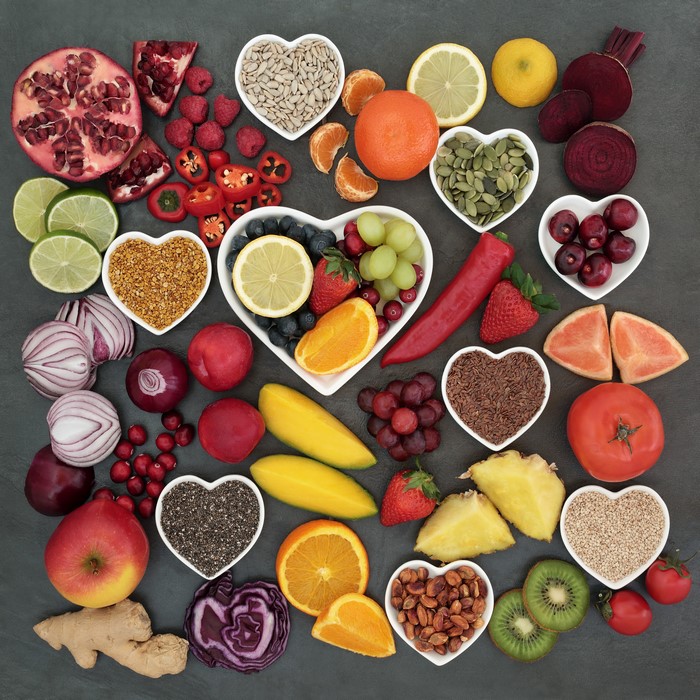 Heart-shaped bowls of healthy foods and fruits
