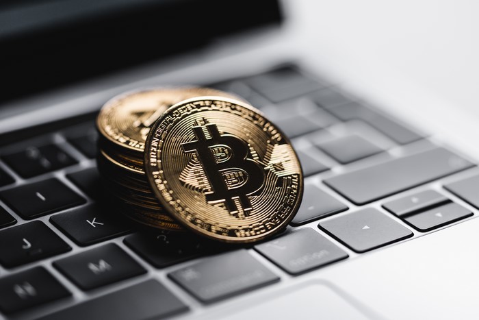 Bitcoin coins on a laptop keyboard