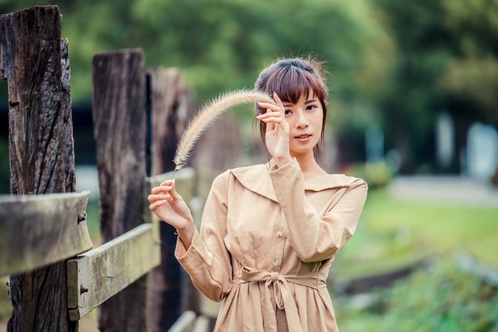 4K Asian Woman Holding Feather Outdoors