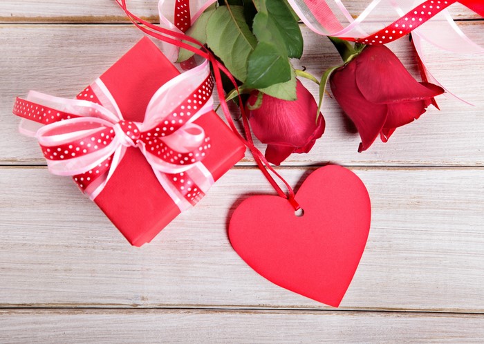 Red gift box with roses and heart tag