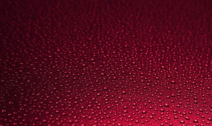 Red background with water drops texture
