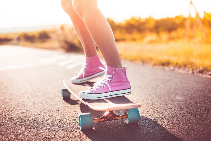 Person on Skateboard Wearing Pink Plimsoll Shoes