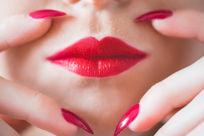 Close-up of Red Lips and Fingernails