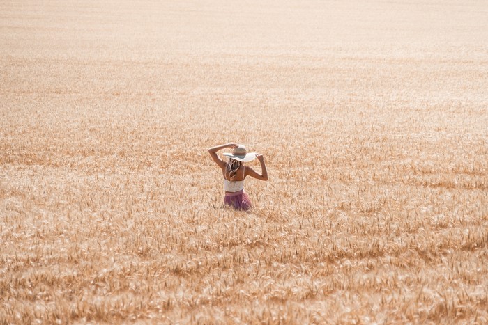 Woman in a hat in a wheat field