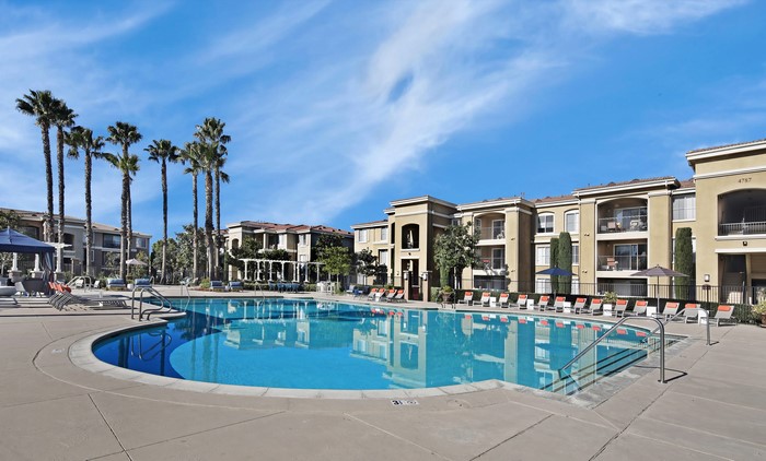 Apartment complex with pool and palm trees in San Jose, California