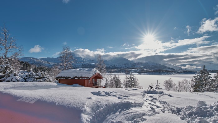 Winter cabin in Norway with snow and sun