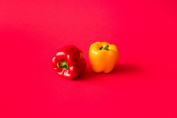 Two Bell Peppers on Red Background