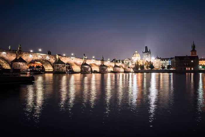 Charles Bridge at night over Vltava river in Prague, Czech Republic