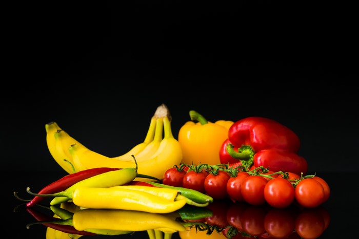 Bananas, Bell Peppers, Tomatoes, and Chili Peppers on Black Background