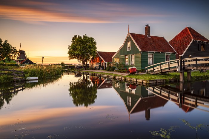 Zaanse Schans canal houses and windmill at sunset, Netherlands