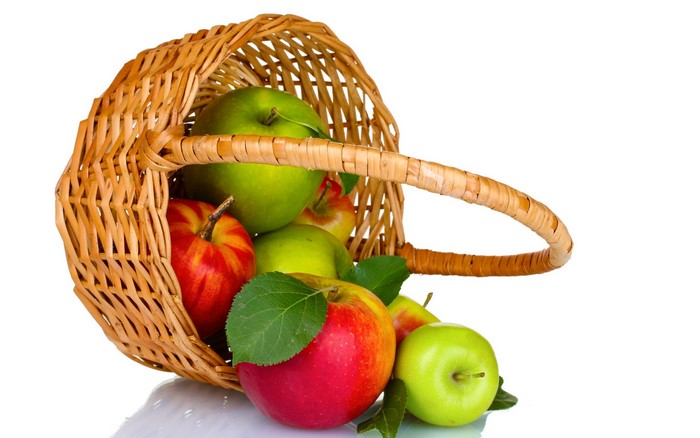 Apples spilling out of a wicker basket