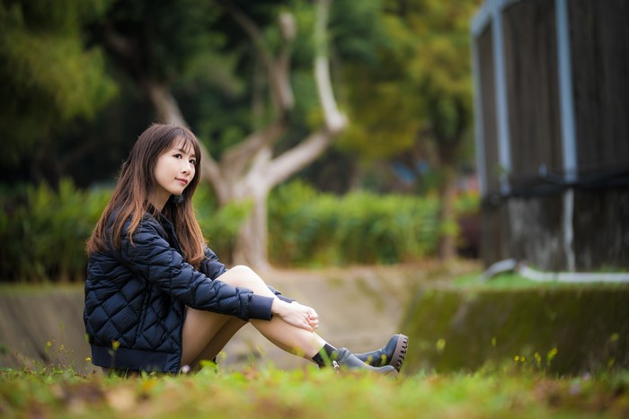 4K Asian Woman Sitting Outdoors with Jacket