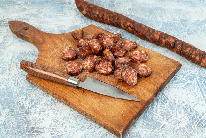 Sliced Sausage on Cutting Board with Knife