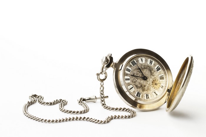 Pocket watch with chain on white background