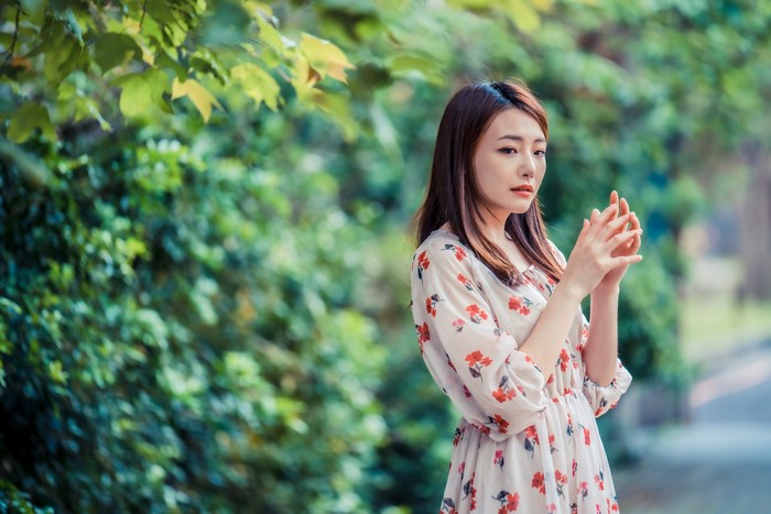 Asian woman with brown hair in a floral dress