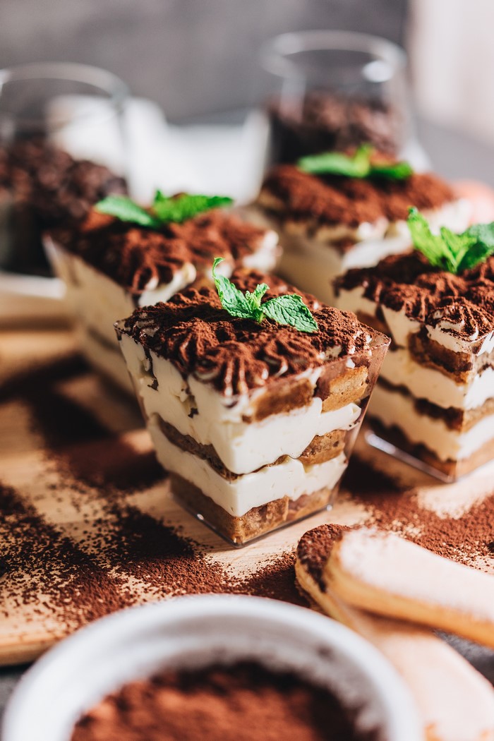 Tiramisu desserts with mint and cocoa powder