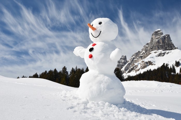 Snowman in a snowy mountain landscape