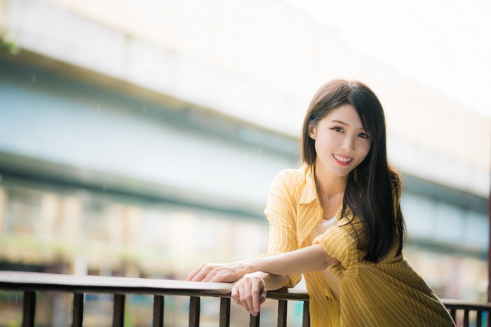 4K Portrait of Smiling Asian Woman in Yellow Shirt