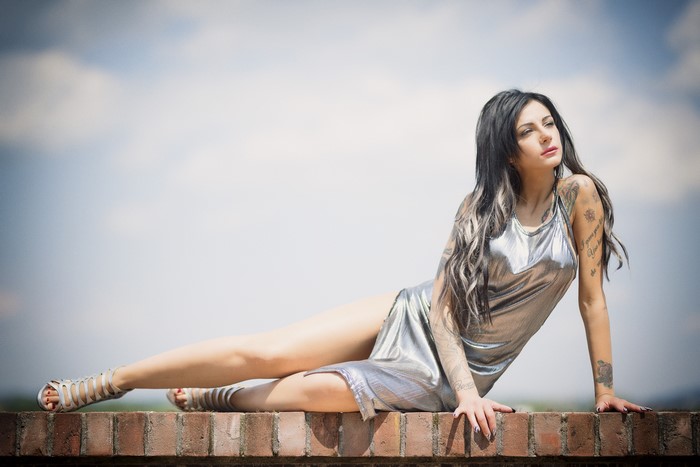 Brunette Woman Posing in Metallic Dress