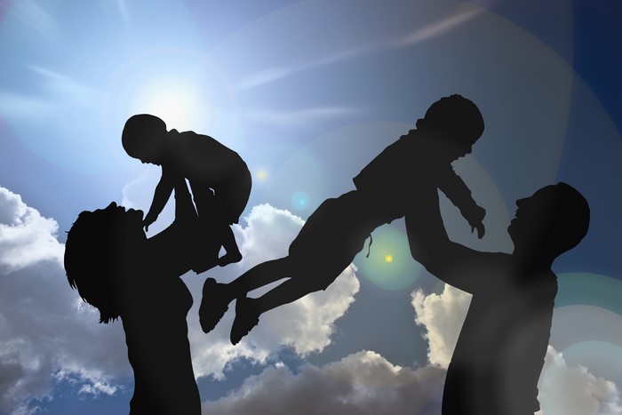 Family Silhouettes Against a Sunny Sky