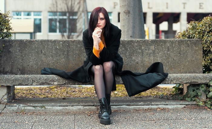 Woman sitting on a concrete bench