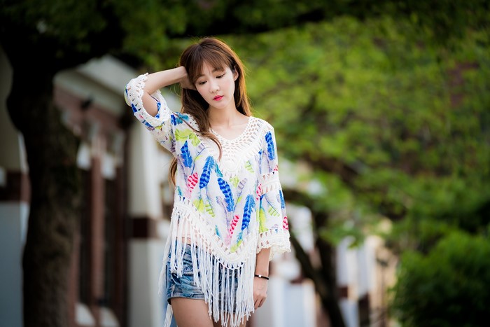 Asian woman with brown hair in a colorful top