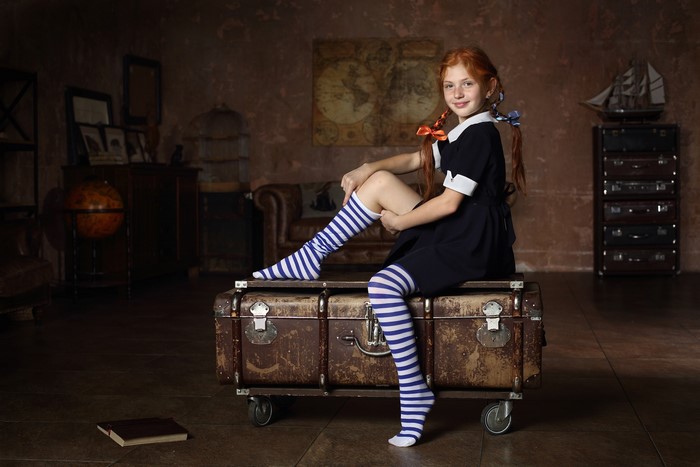 Redhead Schoolgirl Sitting on Vintage Suitcase