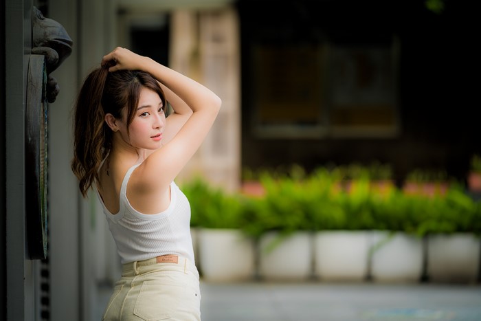 Asian woman with brown hair posing