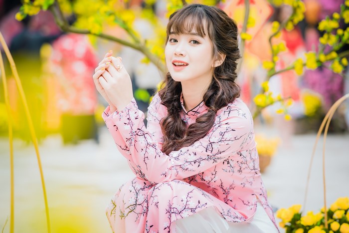 Asian girl in pink floral dress with braided hair