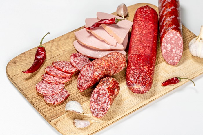 Sausage, Chili Peppers, and Garlic on a Cutting Board