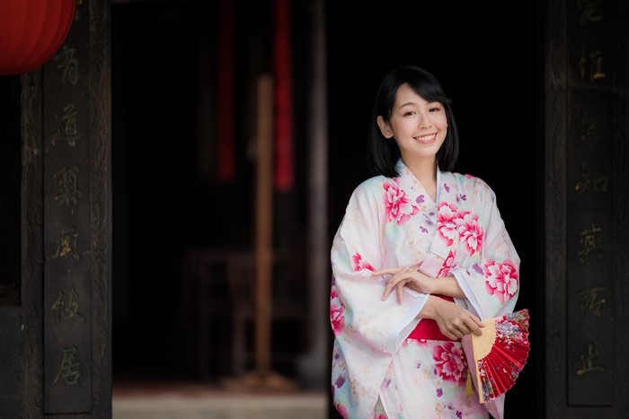 Woman in Kimono holding a fan