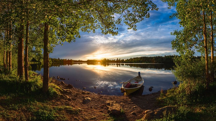 Sunset over River Oulujoki with a boat in Oulu, Finland