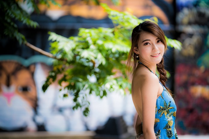 Asian woman with brown hair smiling