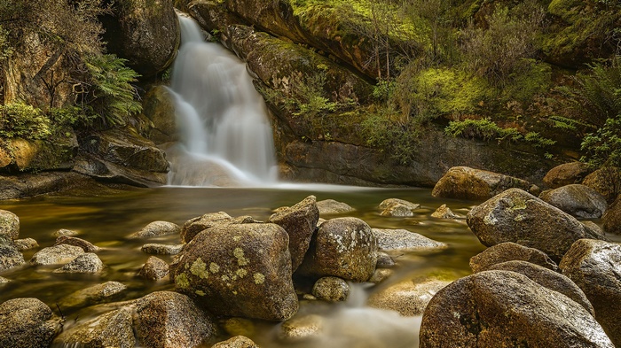 Waterfall cascading over rocks into a stream