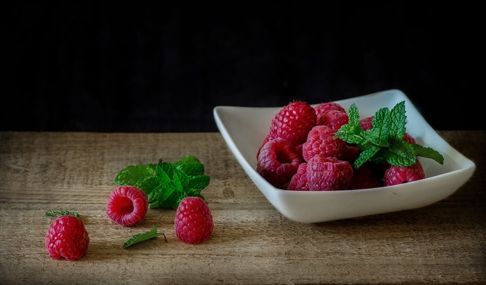 Raspberries and mint in a bowl
