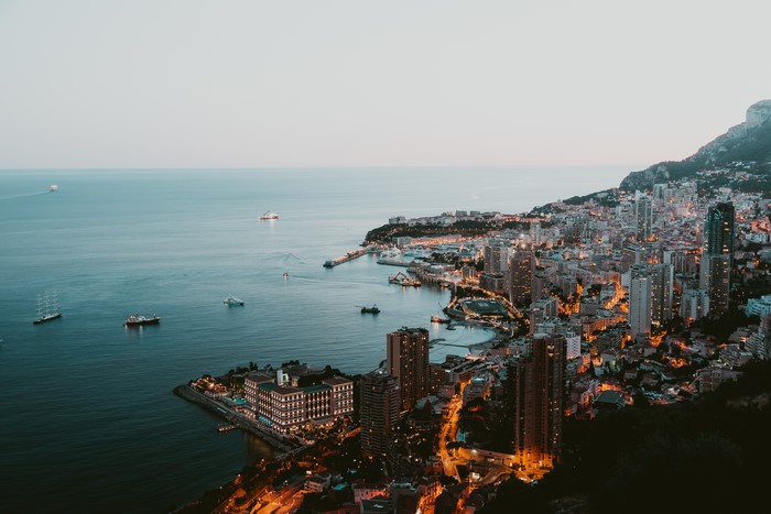 Monaco coast with ships and city lights from above